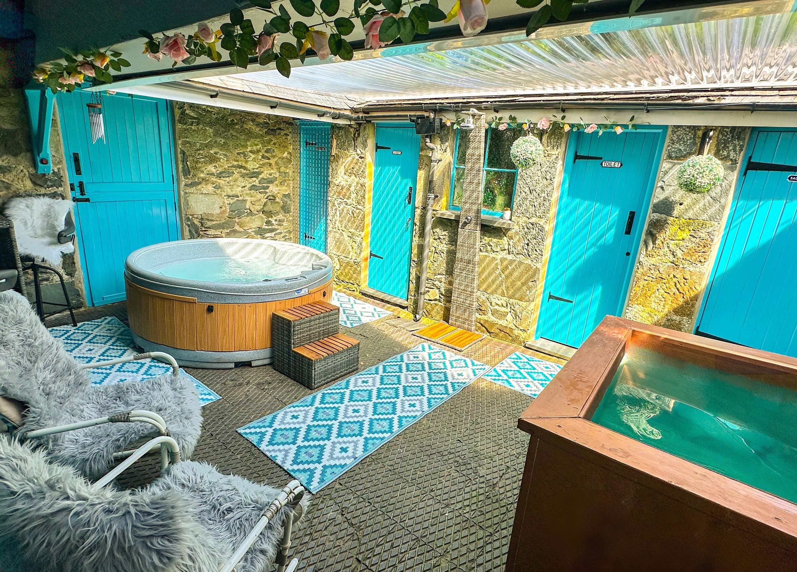 Luxury hot tub area at Plas Courtyard Spa, Llanbedr, Wales, GB with vibrant decor and natural light.