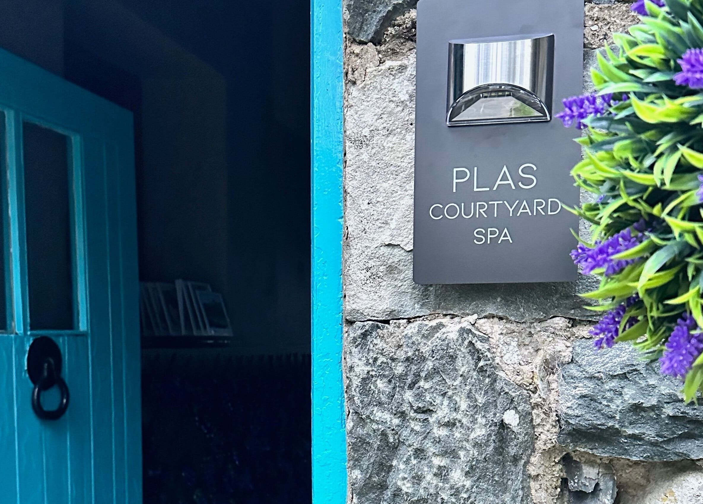 Entrance of Plas Courtyard Spa in Llanbedr, Wales, GB with a distinctive blue door.