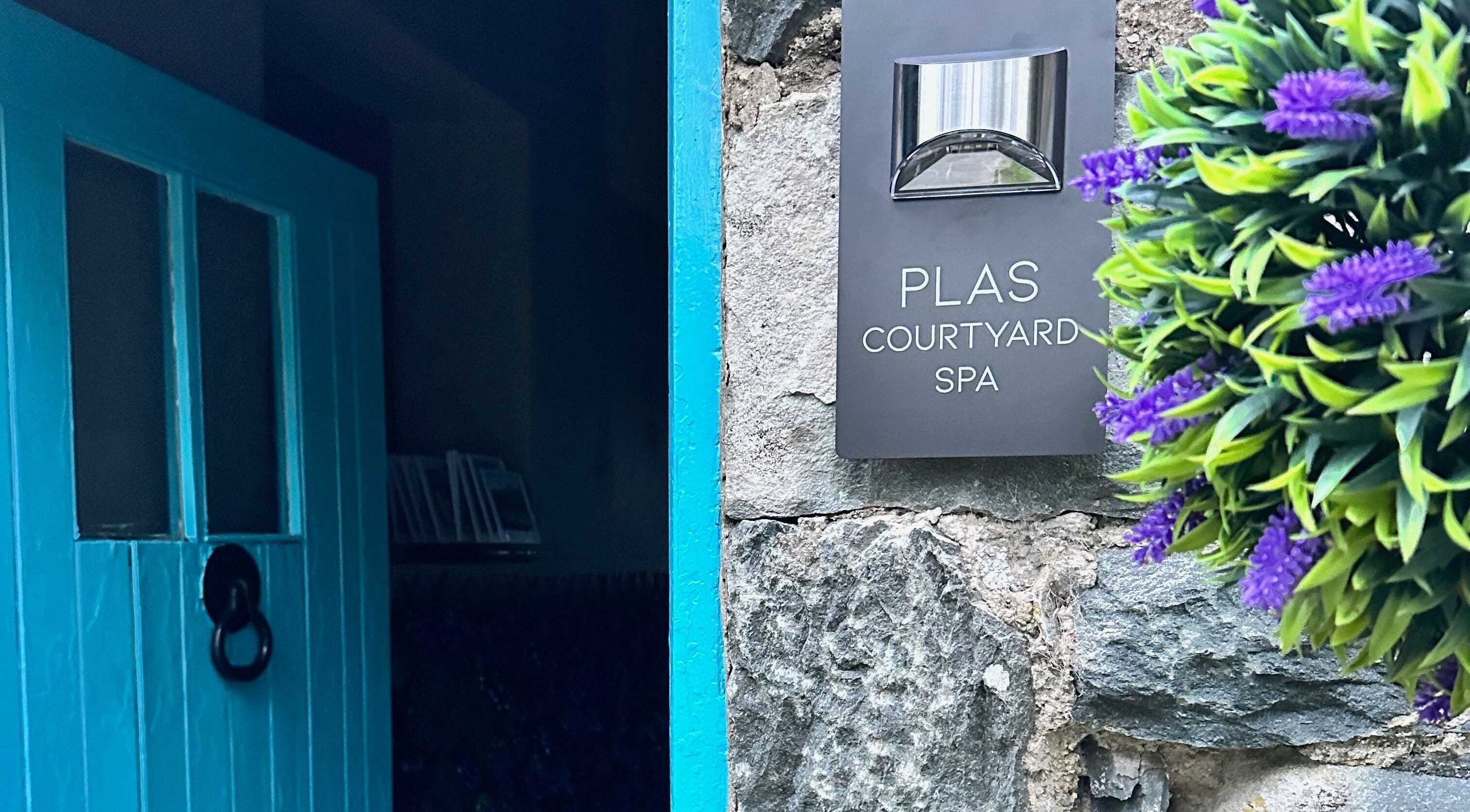 Entrance of Plas Courtyard Spa in Llanbedr, Wales, GB with a distinctive blue door.