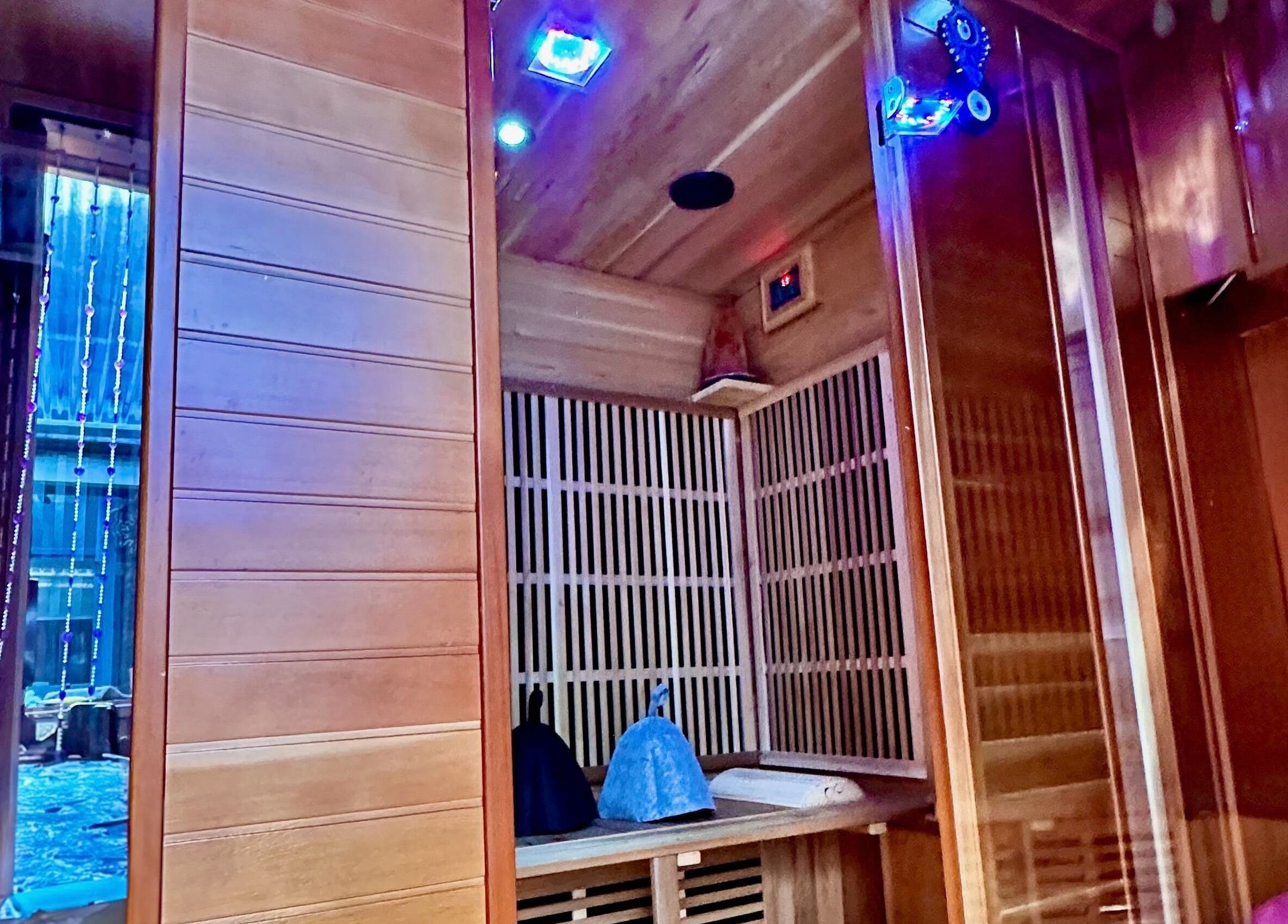 Luxurious sauna interior at Plas Courtyard Spa, Llanbedr, Wales, GB, showcasing wooden design and ambient lighting.
