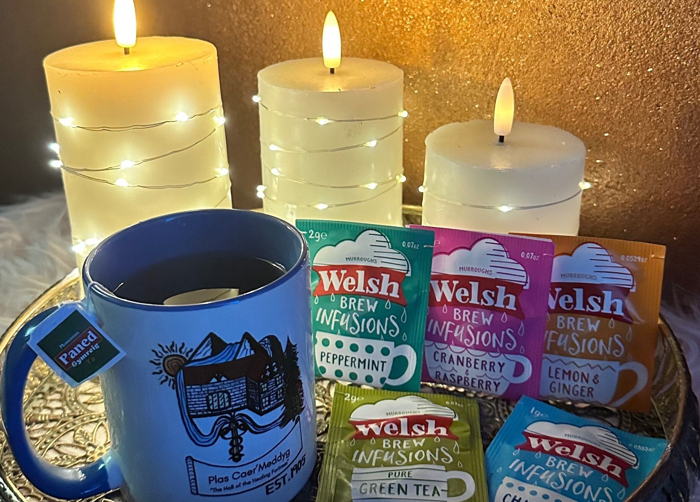Cozy tea setup with candles at Plas Courtyard Spa, Llanbedr, Wales, GB featuring Welsh Brew infusions.