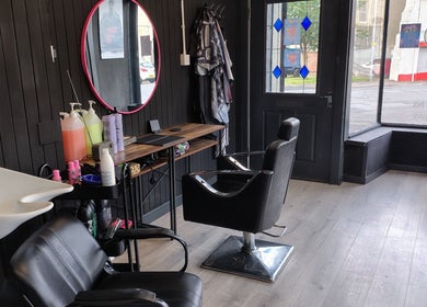 Modern salon interior at Kult Hair in Ayr, Scotland, GB with stylish chairs and vibrant decor.