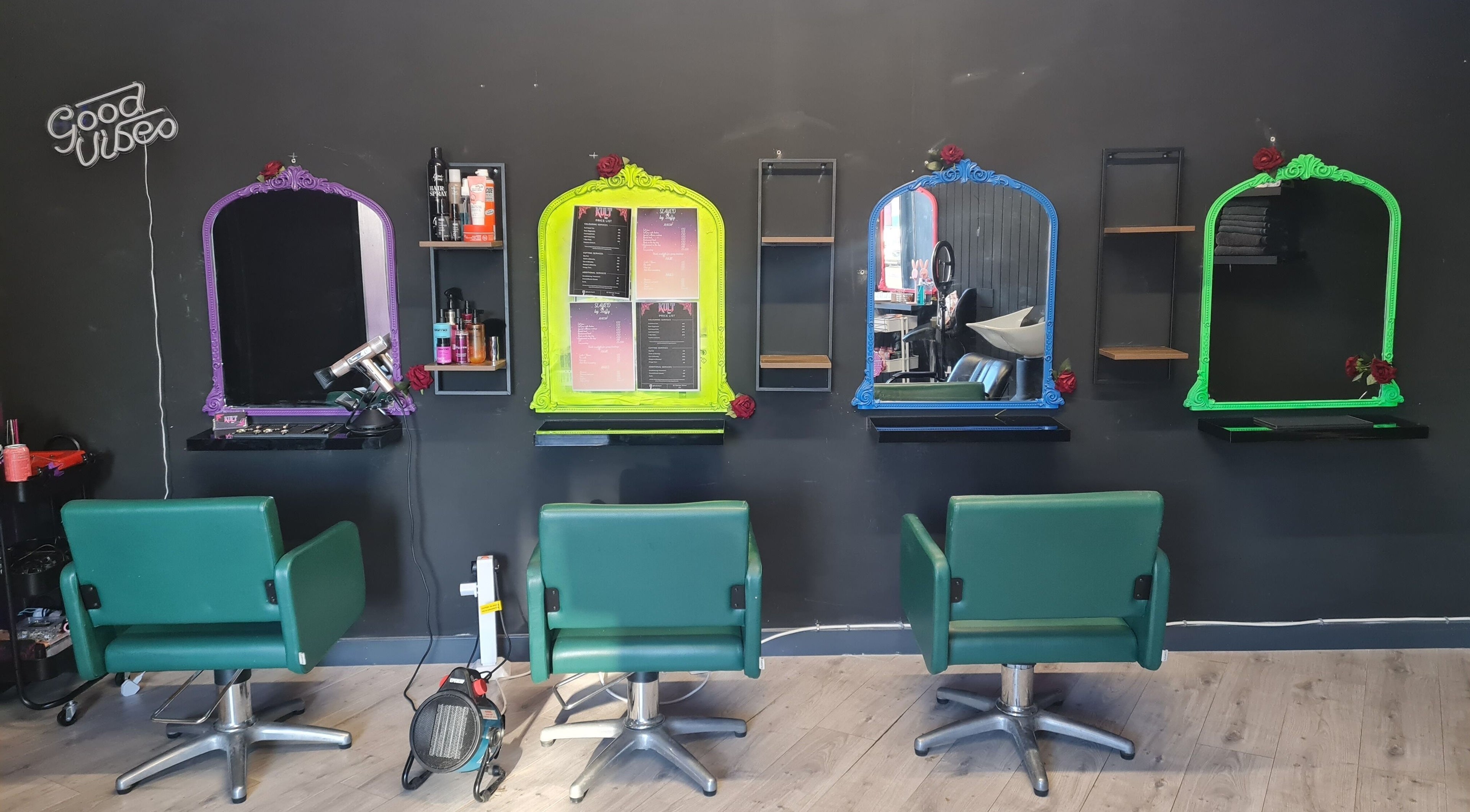 Kult Hair salon's colorful mirror setup in Ayr, Scotland, GB, showcasing vibrant green chairs.