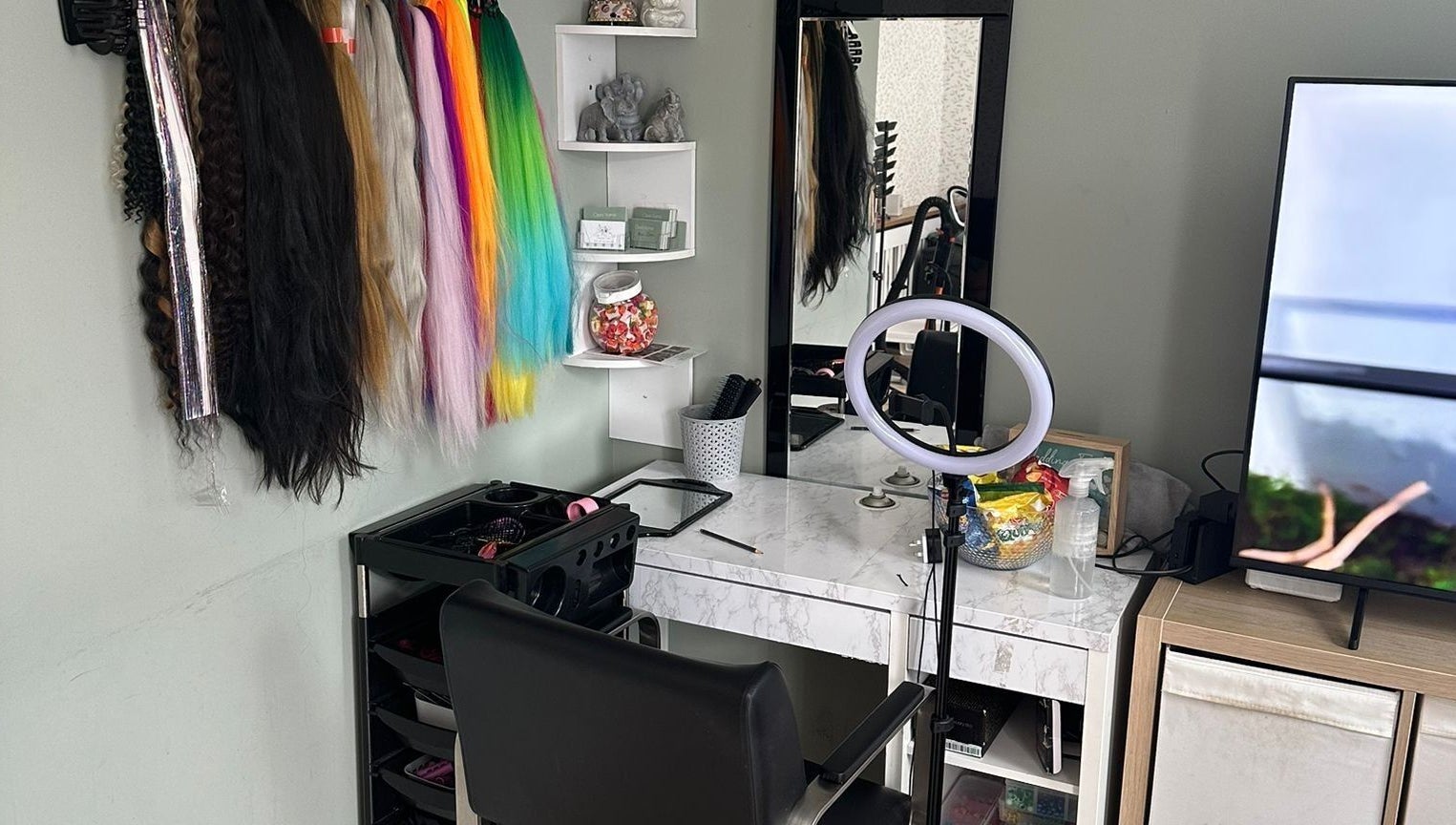 Colorful hair extensions displayed at Hair Me Out, Dagenham, England, GB beauty station with professional setup.