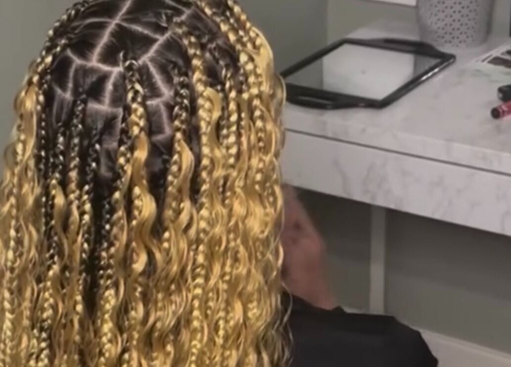 Intricate braided hairstyle at Hair Me Out, Dagenham, England, GB showcasing skilled craftsmanship.