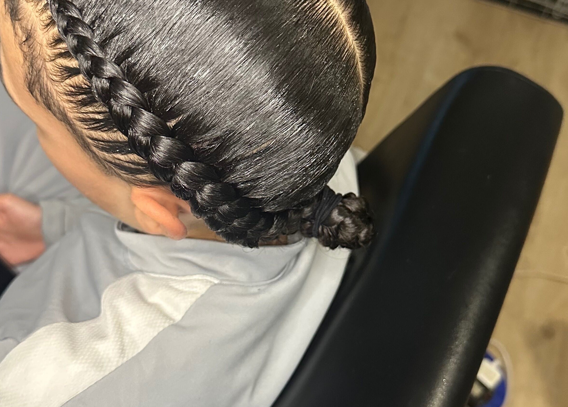 Intricate braid style at Hair Me Out, Dagenham, England, GB showcases sleek and polished hair looks.