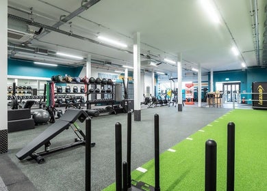 Spacious gym layout at Iron Minds Coaching, Letchworth Garden City, England, GB, showcasing equipment and vibrant space.