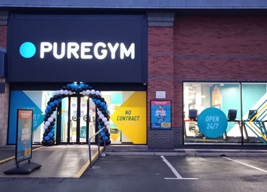 Entrance of PureGym with balloons in Letchworth Garden City, England, GB near Iron Minds Coaching.