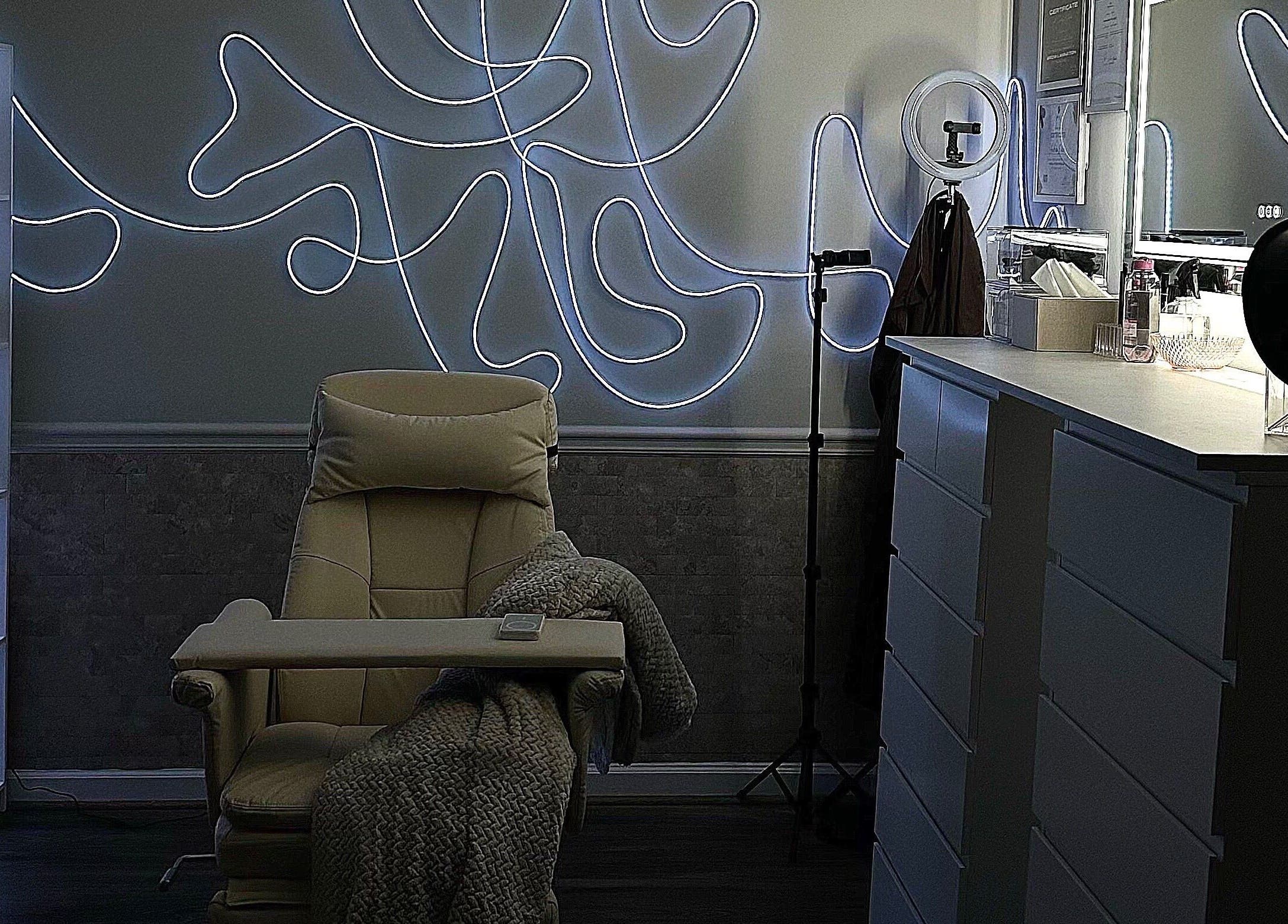 Modern beauty room at Luxe by Lia, featuring ambient lighting and plush chair in Atlanta, Georgia, US.