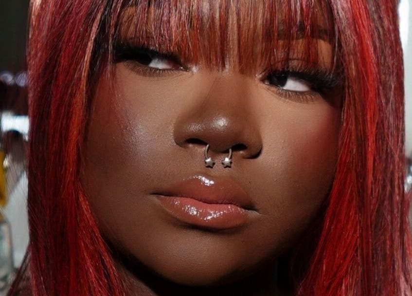 Close-up of a woman's face with vibrant makeup at Luxe by Lia in Atlanta, Georgia, US.