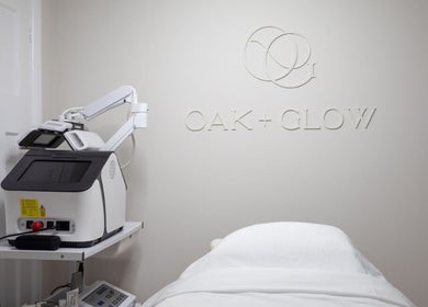 Modern treatment room at Oak + Glow in Chaldon, England, GB, featuring advanced beauty equipment.