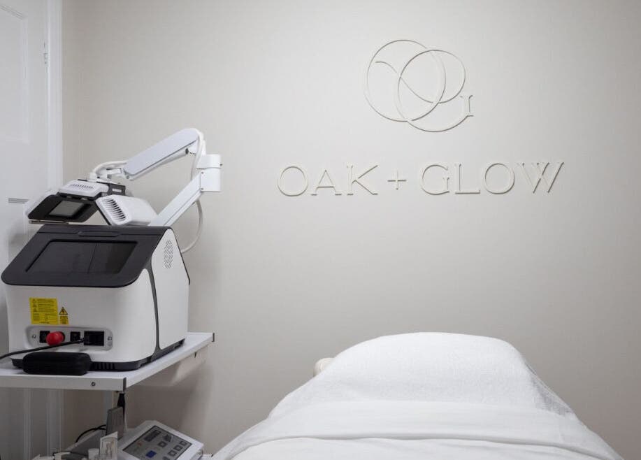 Modern treatment room at Oak + Glow in Chaldon, England, GB, featuring advanced beauty equipment.
