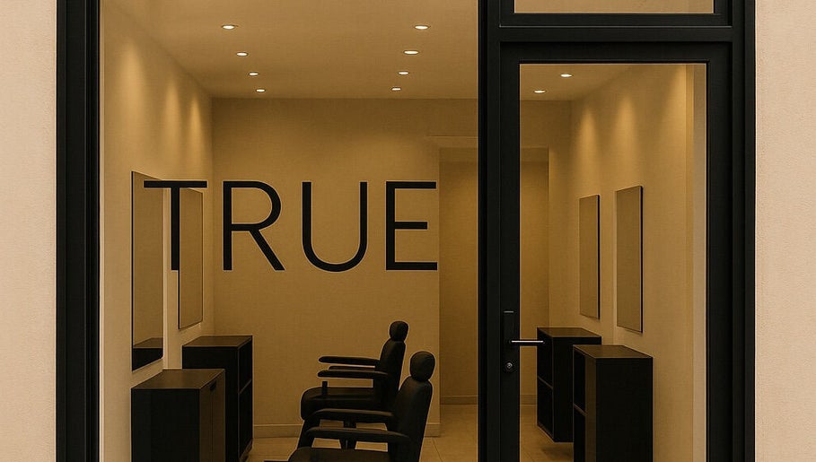 Entrée de True Hair Studio à Blois, Centre-Val de Loire, FR avec mobilier moderne et éclairage chaleureux.