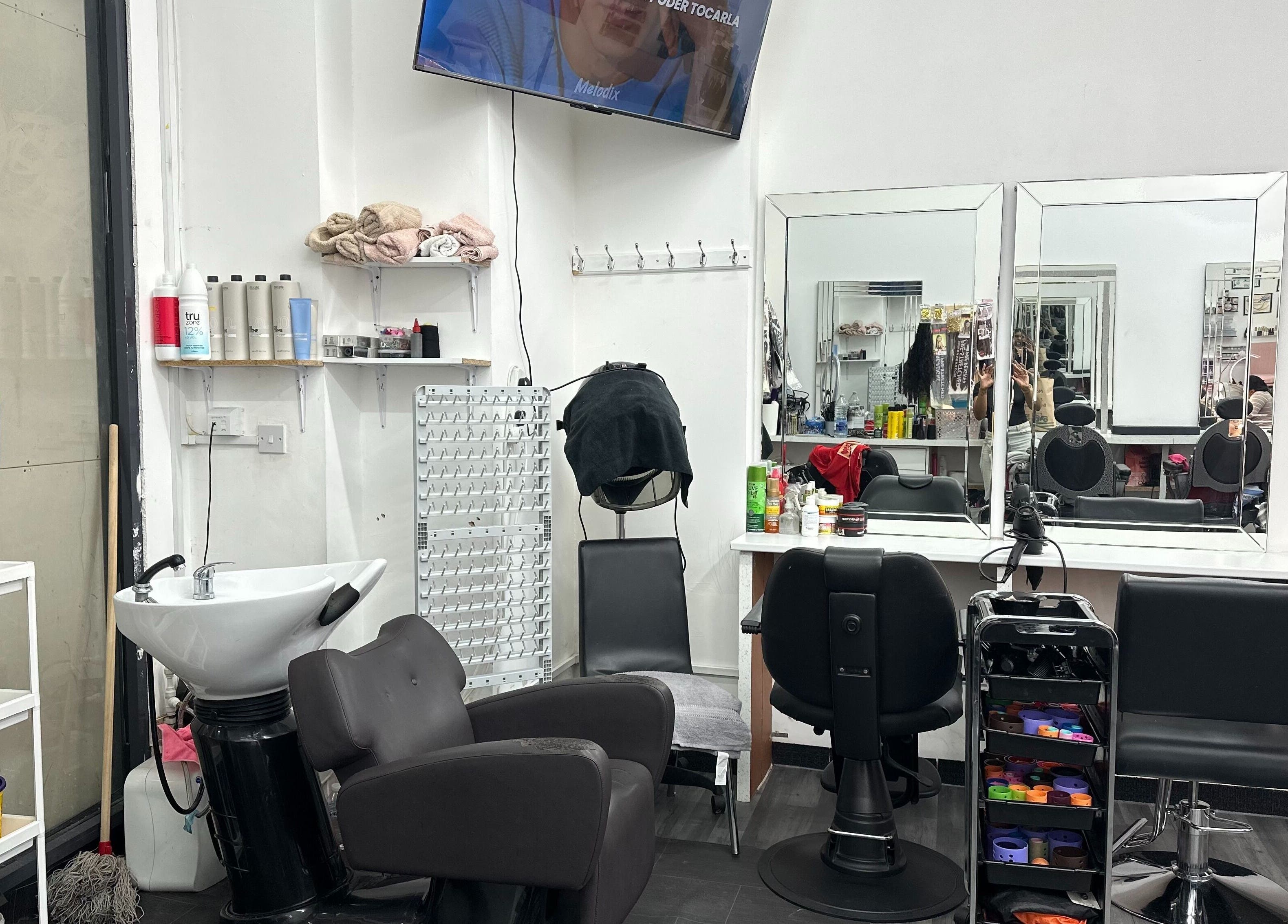 Modern salon interior at Zulymar Beauty & Health, London, England, GB. Features styling chairs and mirrors.