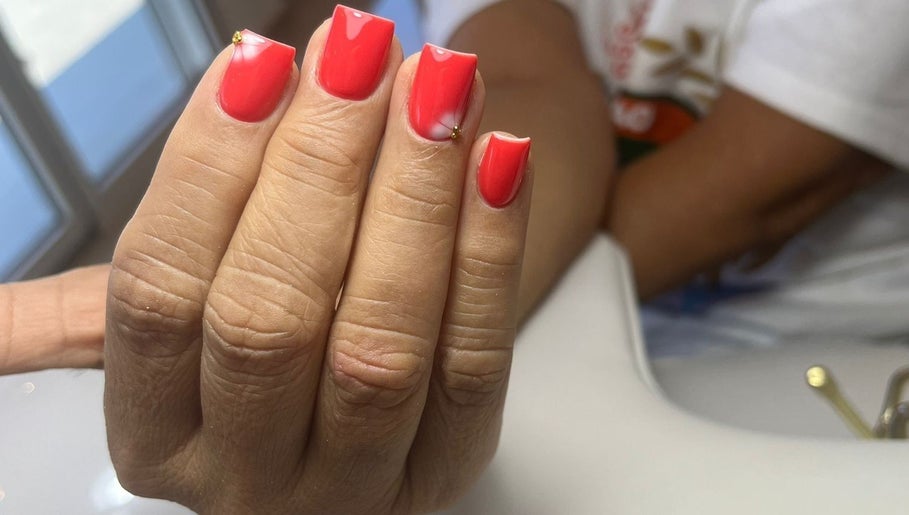 Bright red manicure at Shashi Nails in Willemstad, Curaçao, CW with elegant nail art detail.