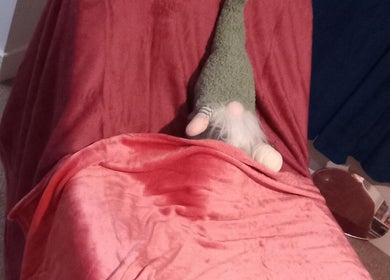 A charming gnome on a plush pink chair at Beauty and Care, Middlesbrough, England, GB.