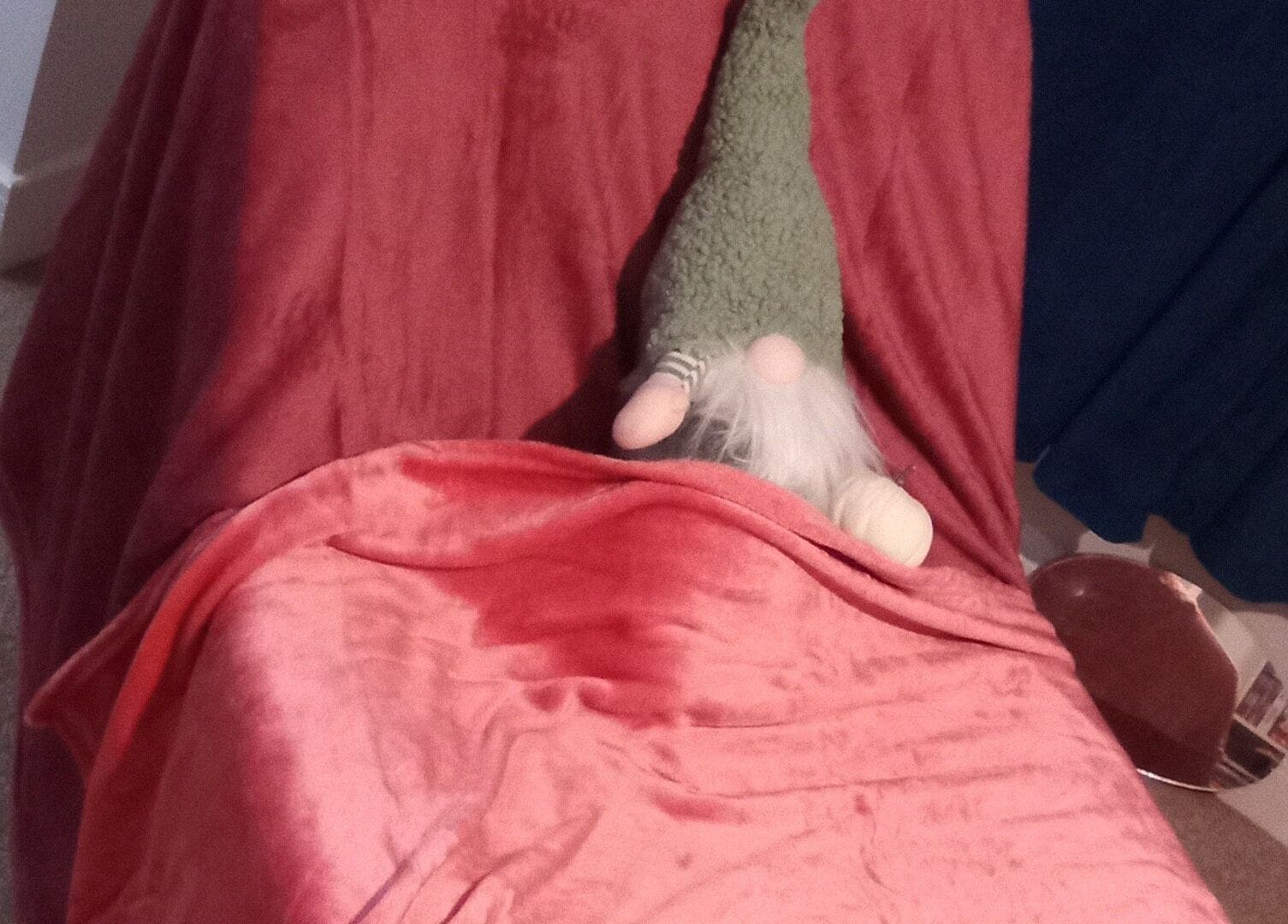 A charming gnome on a plush pink chair at Beauty and Care, Middlesbrough, England, GB.