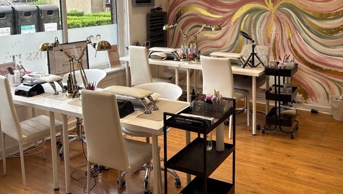 Chic nail salon interior at Lucky Eleven, Whitburn, Scotland, GB with artistic wall mural and modern decor.