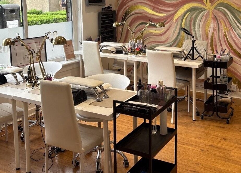 Chic nail salon interior at Lucky Eleven, Whitburn, Scotland, GB with artistic wall mural and modern decor.