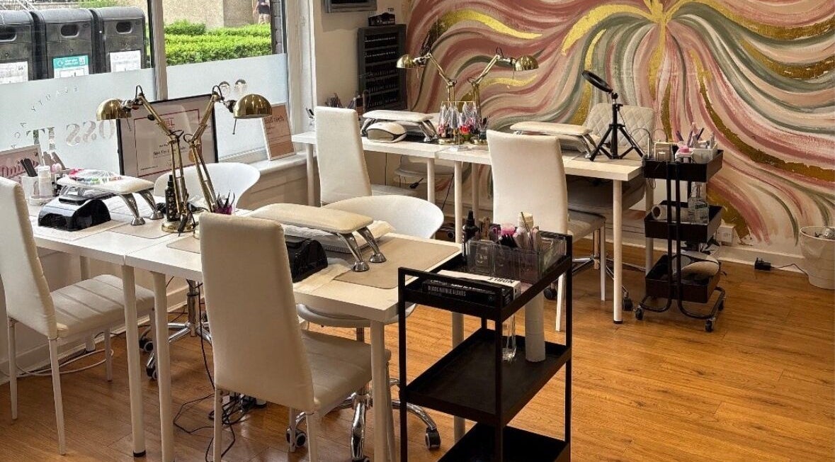 Chic nail salon interior at Lucky Eleven, Whitburn, Scotland, GB with artistic wall mural and modern decor.