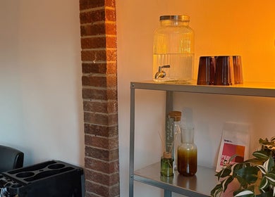 Cozy salon space at Bybrylangford, Rainworth, England, GB with soft lighting and a chic shelf display.