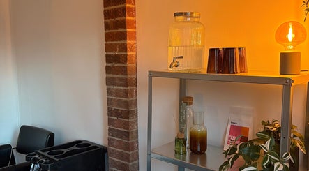 Cozy salon space at Bybrylangford, Rainworth, England, GB with soft lighting and a chic shelf display.