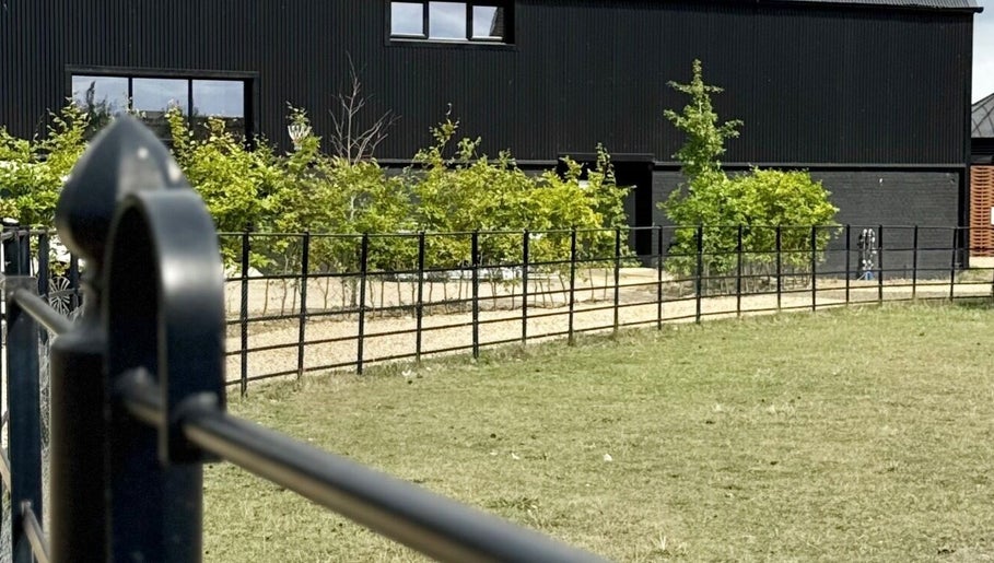 Exterior of Calmia Treatments, Stamford, England with modern design and lush greenery.