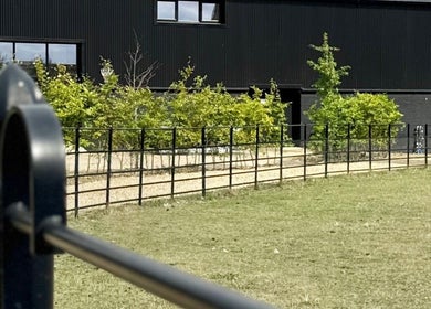 Exterior of Calmia Treatments, Stamford, England with modern design and lush greenery.