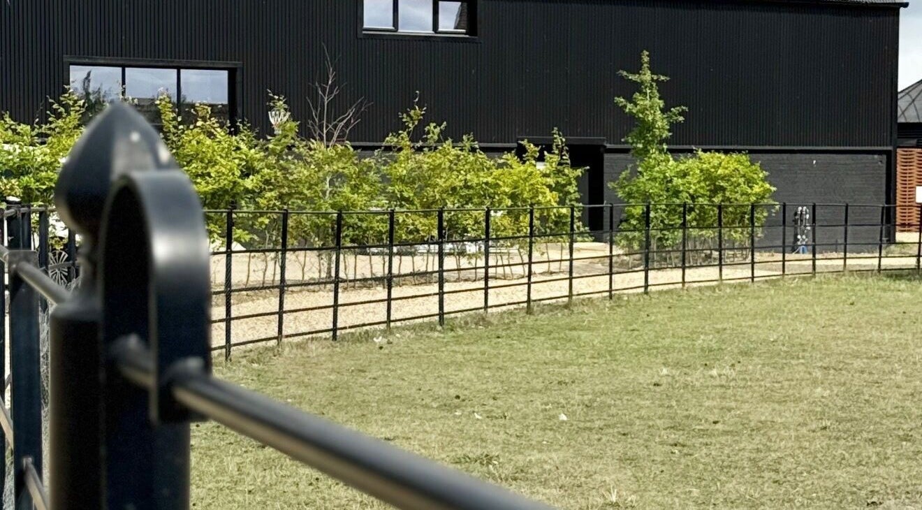 Exterior of Calmia Treatments, Stamford, England with modern design and lush greenery.