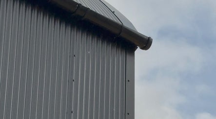 Modern tin roof detail at Calmia Treatments, Stamford, England, GB, showcasing industrial beauty.