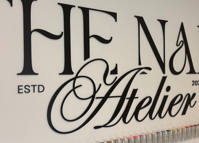 Elegant 'The Nail Atelier Co.' sign with colorful nail polishes, Chelmsford, England, GB.
