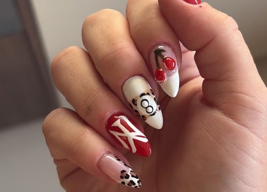Vibrant nail art at The Nail Atelier Co., Chelmsford, England, GB, featuring red, white, and leopard designs.