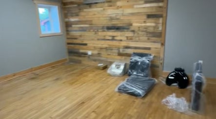 Cozy rustic interior of Tekh Hair Studio LLC, Hilton, New York, US with wooden accents and salon equipment.