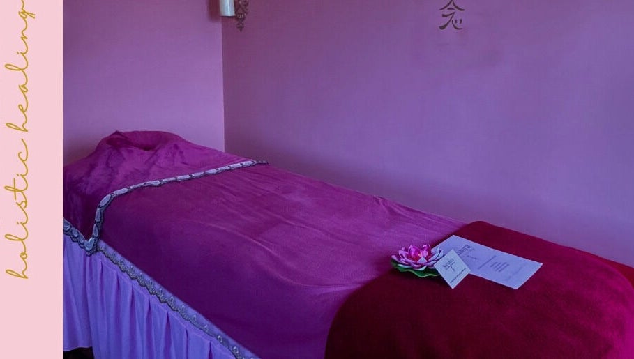 Relaxing spa room at Nomaura, Pontypool, Wales, GB with a plush bed draped in pink fabric.