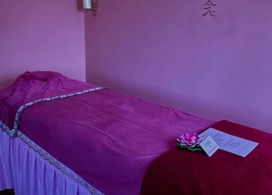 Relaxing spa room at Nomaura, Pontypool, Wales, GB with a plush bed draped in pink fabric.