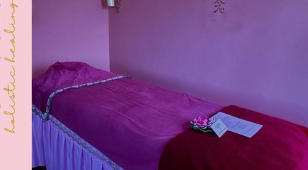 Relaxing spa room at Nomaura, Pontypool, Wales, GB with a plush bed draped in pink fabric.