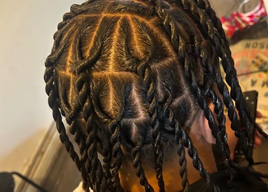 Intricate braided hairstyle at Hairbyreshi, Wolverhampton, England, GB showcasing unique design.