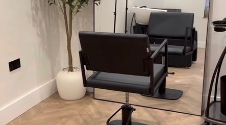 Modern salon interior with a styling chair at LUCY MARIE HAIR, Colchester, England, GB.