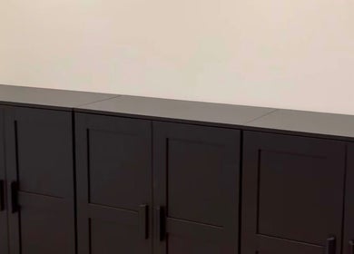Sleek black cabinets at LUCY MARIE HAIR, Colchester, England, GB, offering modern storage solutions.