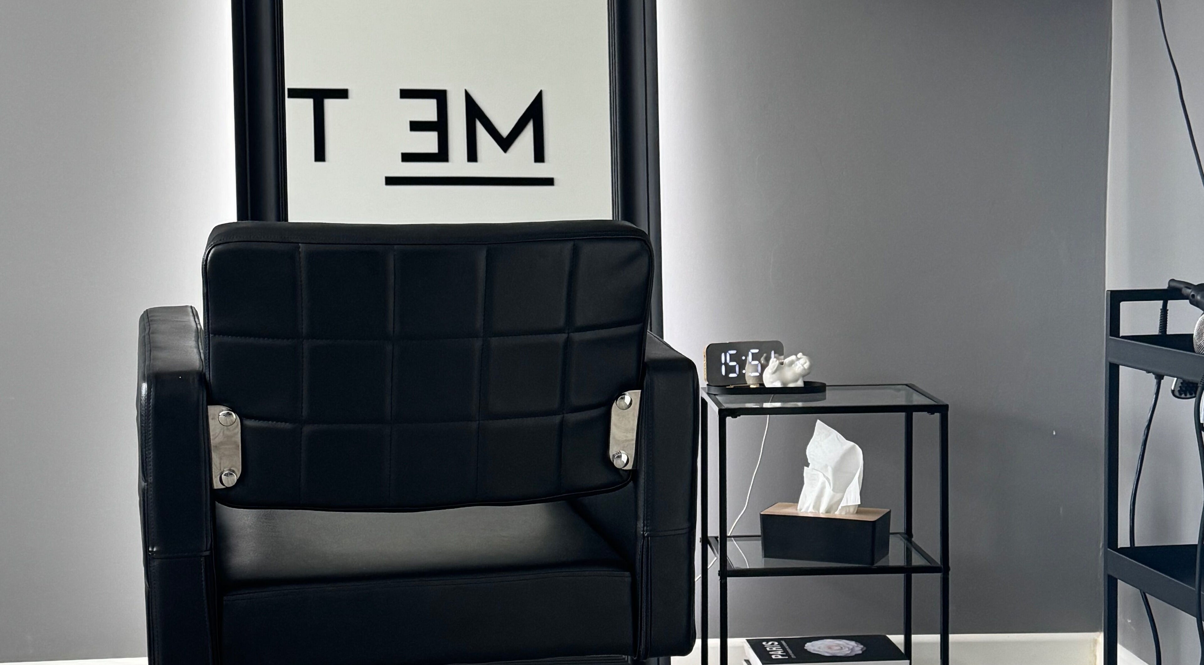 Modern black chair setup at ME TIME STUDIO, Jelgava, LV, featuring sleek design and cozy ambiance.