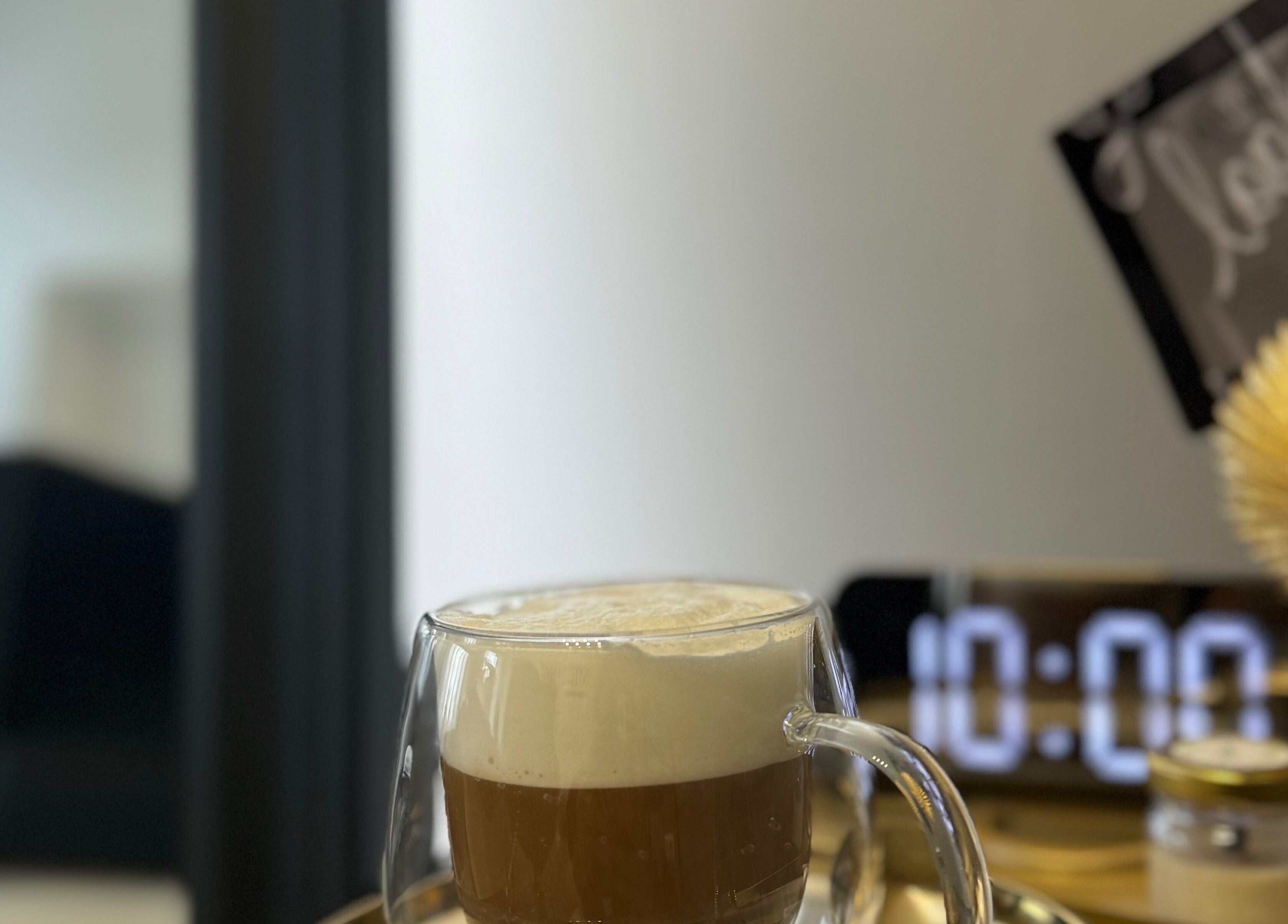 A latte in a glass cup at ME TIME STUDIO, Jelgava, LV, creating a relaxing atmosphere.