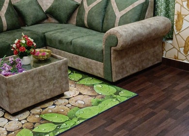 Chic green sofa with floral decor at Footvarma, Chennai, Tamil Nadu, IN.