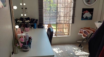 Bright, elegant corner of D's Hair Salon in Krugersdorp, Gauteng, ZA, featuring a stylish makeup desk and mirror.