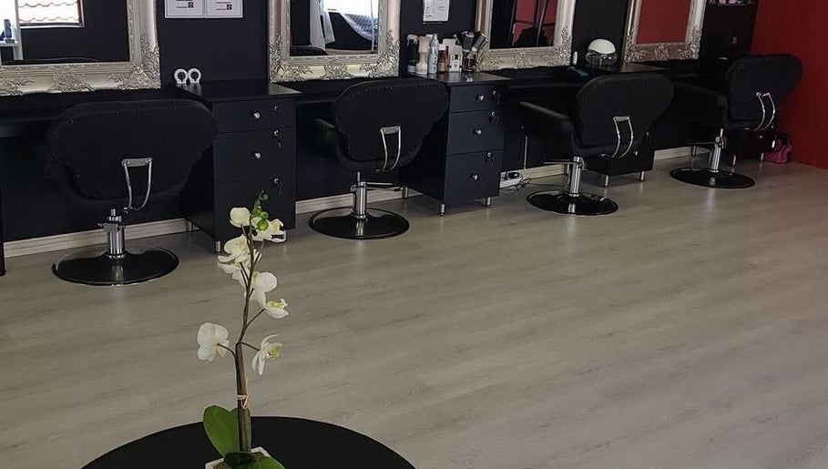 Stylish interior of D's Hair Salon in Krugersdorp, Gauteng, ZA featuring modern salon chairs and mirrors.