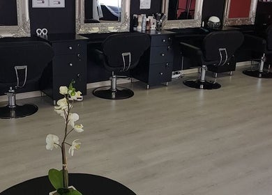 Stylish interior of D's Hair Salon in Krugersdorp, Gauteng, ZA featuring modern salon chairs and mirrors.