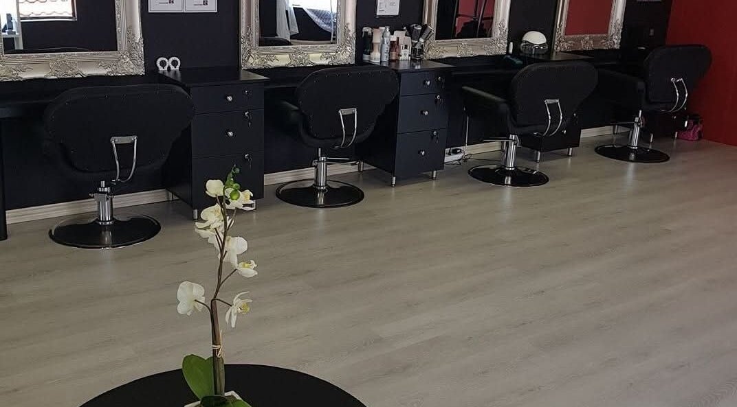 Stylish interior of D's Hair Salon in Krugersdorp, Gauteng, ZA featuring modern salon chairs and mirrors.