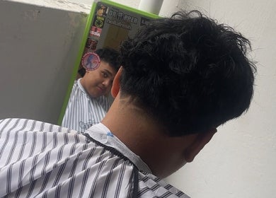 Client viewing fresh haircut in mirror at gblendez, Singapore, Singapore, SG salon.