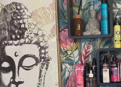 Stylish beauty product shelf with Buddha art at Jades Gorgeous Hair, Leighton Buzzard, England, GB.