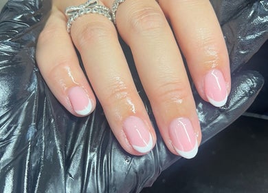 Stylish French manicure at The Nail Lab Essex in Witham, England, GB, displaying elegant pink nail art.