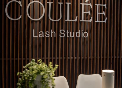 Entrance of Coulée Lash Studio in Sandton, Gauteng, ZA with sleek wooden decor.